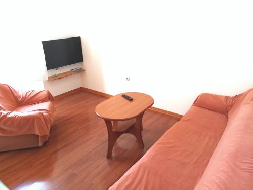 a living room with a couch and a table at Apartment Šibenik Mandalina in Šibenik