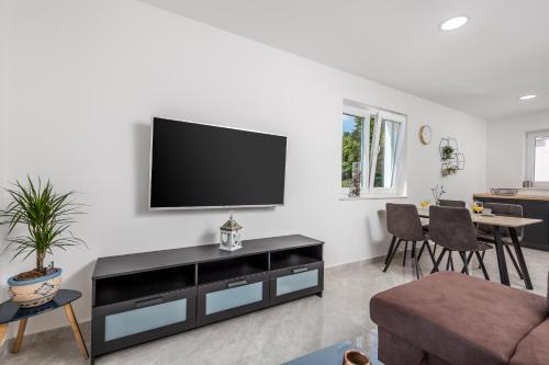a living room with a flat screen tv on a wall at Villa Zita Lovran in Opric