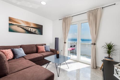 a living room with a couch and a view of the ocean at Villa Zita Lovran in Opric