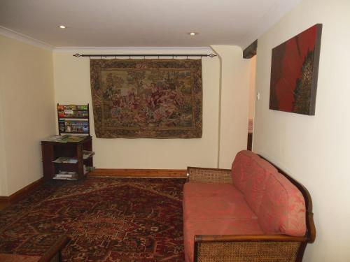 a living room with a red couch and a rug at Highfield Farm in Sandy