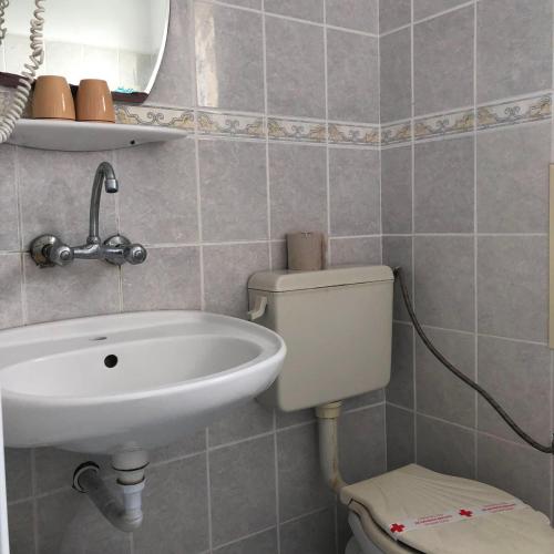 a bathroom with a sink and a toilet at Sunny Varshava Hotel in Golden Sands