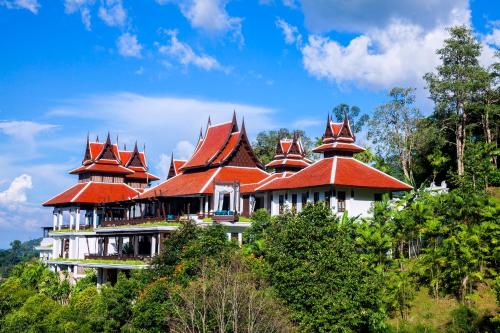 a building with red roofs on top of a hill at Panviman Chiang Mai Spa Resort in Mae Rim