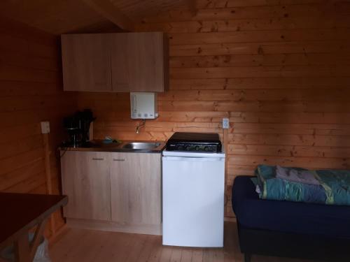 a kitchen with a stove and a refrigerator in a room at Alte Mühle 2 in Licherode