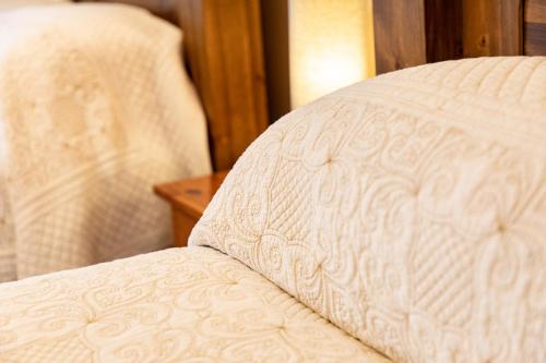a close up of a white bed with at Twin Peaks B&B in Doolin