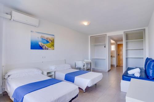 Ένα ή περισσότερα κρεβάτια σε δωμάτιο στο Las Palomas Apartments Econotels