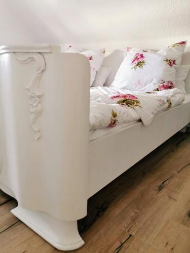 a white bed with pillows on it in a room at Ferienhaus Rosmarie am Elbradweg in Grödel
