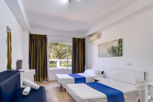 Ένα ή περισσότερα κρεβάτια σε δωμάτιο στο Las Palomas Apartments Econotels