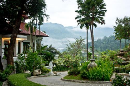 a house with a garden with a view of a mountain at Panviman Chiang Mai Spa Resort in Mae Rim