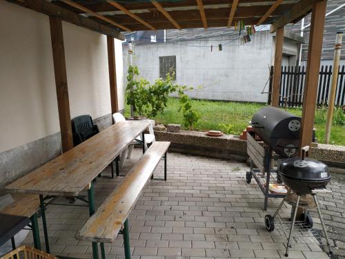 a grill and wooden benches on a patio at Monteur - Ferienwohnung - Marburg-Biedenkopf - Steffenberg - Erdgeschoss mit Balkon in Obereisenhausen