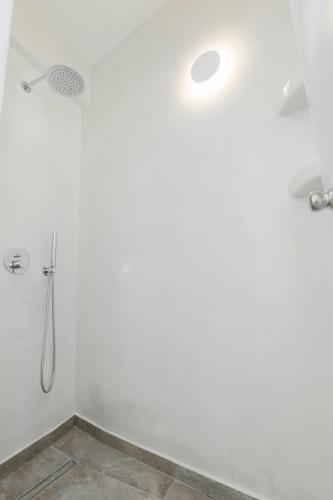 a bathroom with a shower with a shower head at Eternity Suites Santorini in Fira