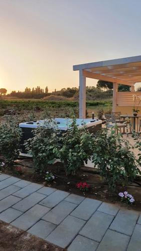 a patio with a pavilion and some plants at Azienda Agricola I Peperoncini in Alghero