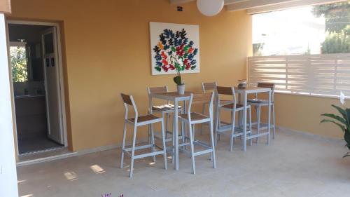 a dining room with a table and stools at Azienda Agricola I Peperoncini in Alghero