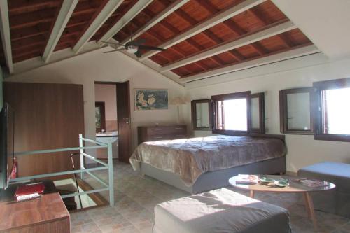 a bedroom with a bed and a living room at Το Σπιτι με την Σπηλιά in Platanias
