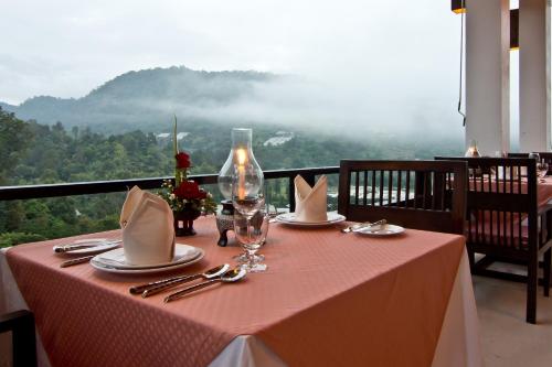 a table with wine glasses and napkins on top at Panviman Chiang Mai Spa Resort in Mae Rim