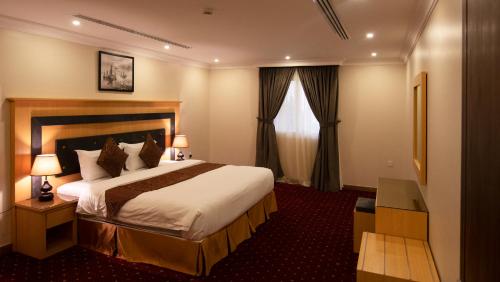 a hotel room with a bed and a window at SHALLY RESIDENCE 3 in Al Khobar