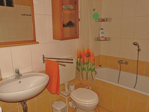 a bathroom with a sink and a toilet and a tub at Raday Central Apartment in Budapest