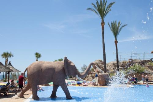 an elephant walking in the water at a resort at Holiday Premium Resort in Benalmádena