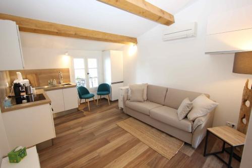 a living room with a couch and a kitchen at Domaine Chateau Martin in Saint-Tropez