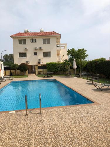a swimming pool in front of a building at Villa Natalia in Ayia Napa