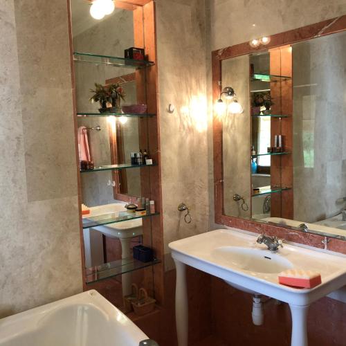 a bathroom with a sink and a mirror and a tub at Villa Natalia in Ayia Napa
