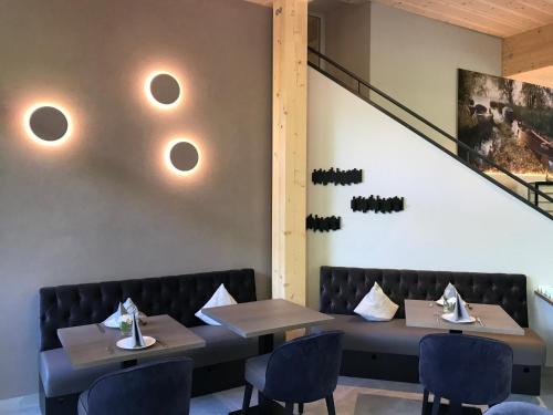 a dining room with two tables and chairs at Hotel Garni Villa Rosengarten in Überlingen