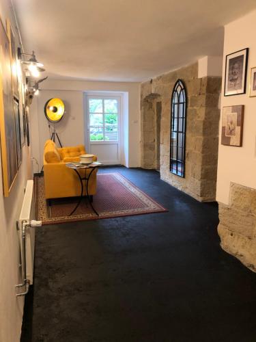 a living room with a yellow couch and a table at Hrensko31 in Hřensko