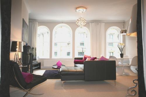 a living room with a couch and a large window at Tyne Bridge View in Newcastle upon Tyne
