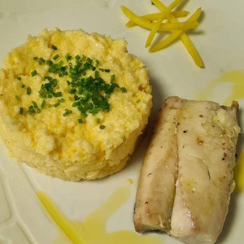 a plate of food with a piece of meat and mashed potatoes at Le Relais Du Mont Blanc in Magland