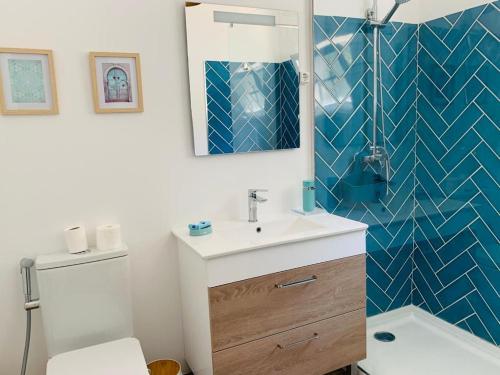 a bathroom with a sink and a toilet and a mirror at Lakeside Rest in Ferreira do Zêzere