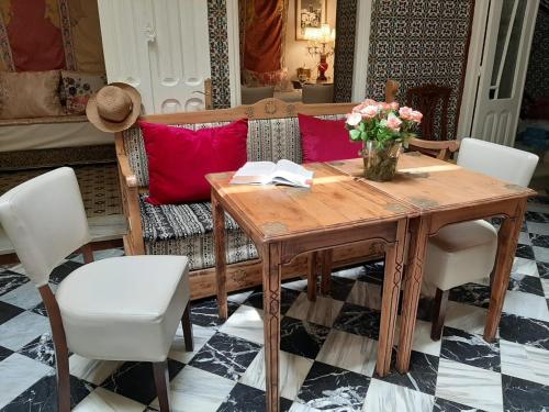 a wooden table with a vase of flowers and a couch at El Reducto in Tetouan
