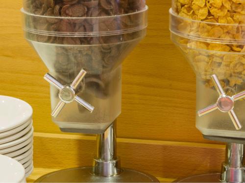 a blender with food inside of it next to a pile of food at ibis Porto Centro São Bento in Porto