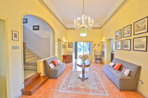 a living room with two couches and a table at Villa Bellavista - Tuscany panoramic view in Crespina