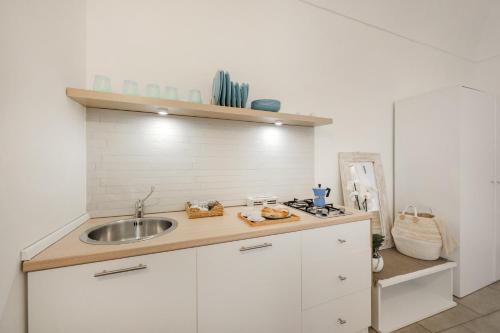 a kitchen with a sink and a counter top at Le Volte Procida Home in Procida