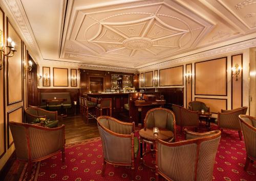 a restaurant with tables and chairs and a ceiling at Best Western Premier Grand Hotel Russischer Hof in Weimar