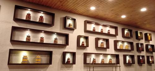 a wall with a bunch of bottles on a wall at The Fern Leo Beach Resort , Madhavpur in Porbandar