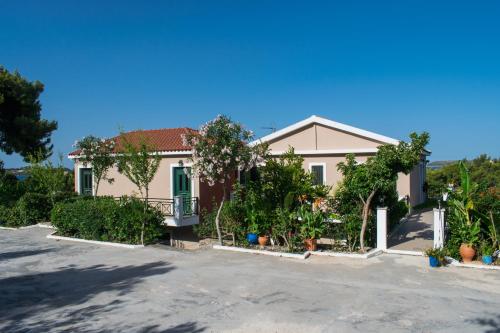 a house with a lot of trees in front of it at Seapine Studios in Lassi