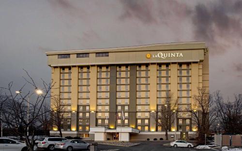 a large hotel with a sign on the top of it at La Quinta by Wyndham Springfield in Springfield
