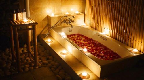 a bath tub with a pizza in it with lights at Arona Villa Sanur in Sanur