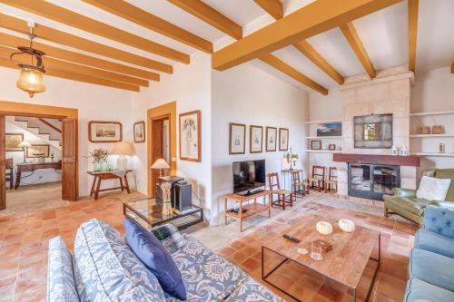 a living room with a blue couch and a fireplace at Son Galiana in Algaida