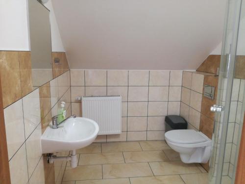 a bathroom with a sink and a toilet at U Justyny in Chróścice