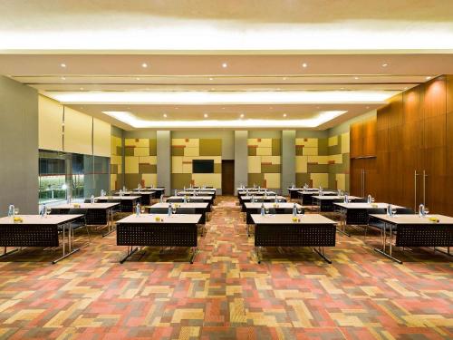 a large dining room with tables and chairs at ibis Nashik - An Accor Brand in Nashik