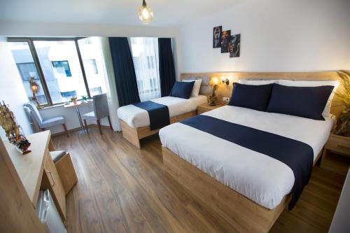 um quarto de hotel com duas camas e um sofá em Golden Street Hotel em Istambul