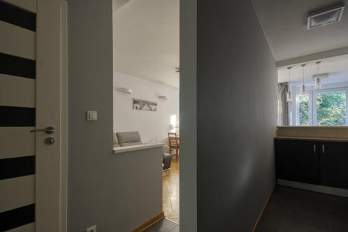 a hallway with a door leading to a living room at aleja 3 maja 7B by Homeprime in Warsaw