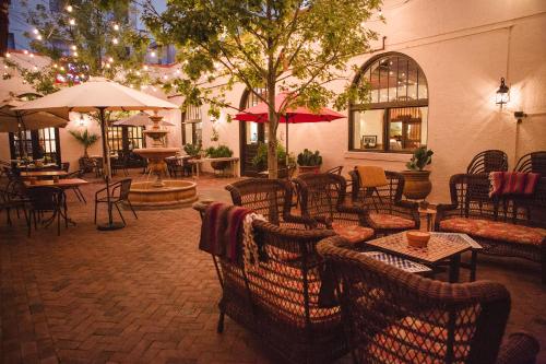 a patio with tables and chairs and tablesktop at The Holland Hotel in Alpine