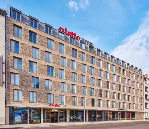 a large brick building with a sign on it at aletto Hotel Potsdamer Platz in Berlin