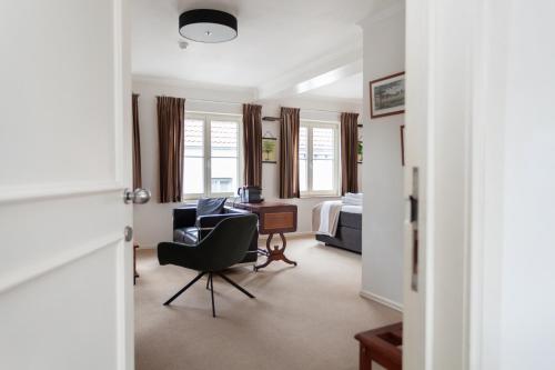 a living room with a chair and a desk at Boutique B&B The Townhouse in Bruges