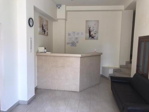 a waiting room with a counter and some stairs at Pensiunea Paradis in Băile Herculane