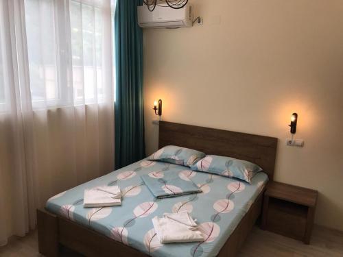 a bedroom with a bed with pink hearts on it at Pensiunea Paradis in Băile Herculane
