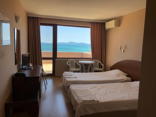 a hotel room with two beds and a view of the ocean at Relax Guest House in Burgas City