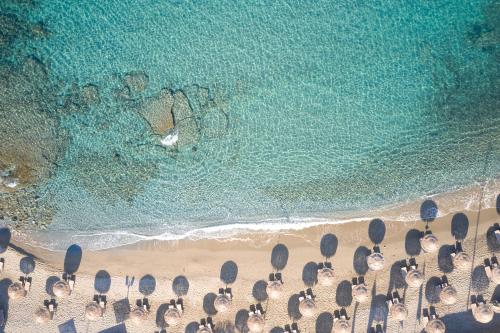 an overhead view of a beach with chairs and the ocean at Vincci EverEden in Anavissos